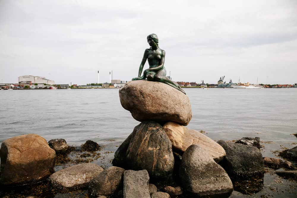 The Little Mermaid, the famous statue that sits on a rock and looks out over the water, from the stories of Hans Christian Anderson, is one of the most famous sights and things to do in Copenhagen Denmark. 