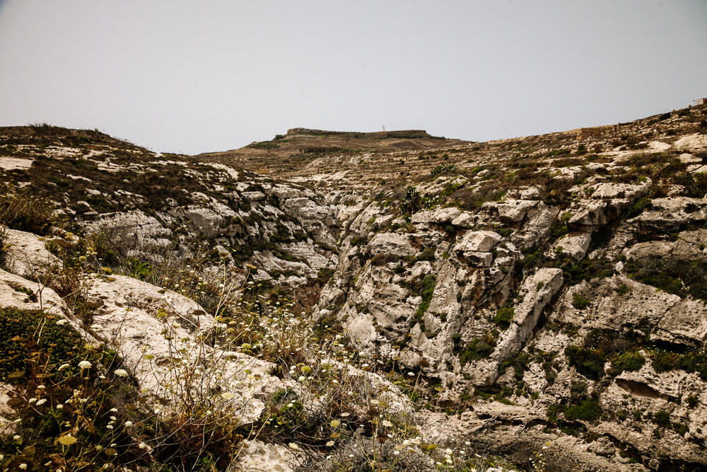 Wied Il-Ghasri is a gorge that flows into the sea.