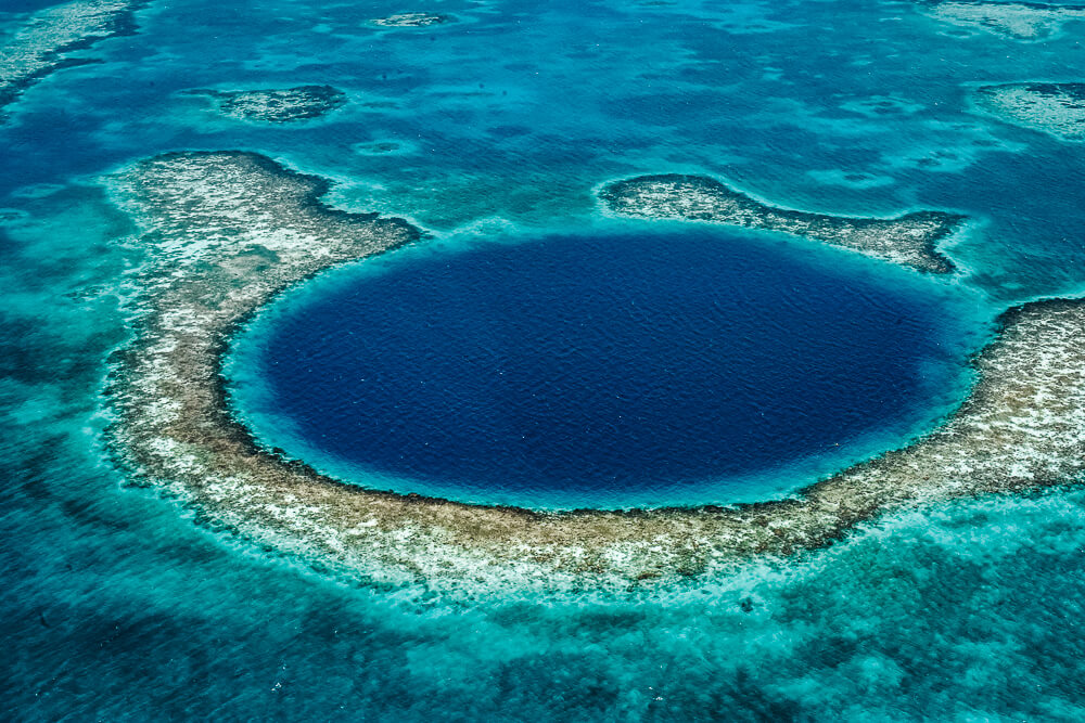 The Great Blue Hole lies within the Belize Barrier Reef near the small atoll Lighthouse Reef and is one of the country's highlights.