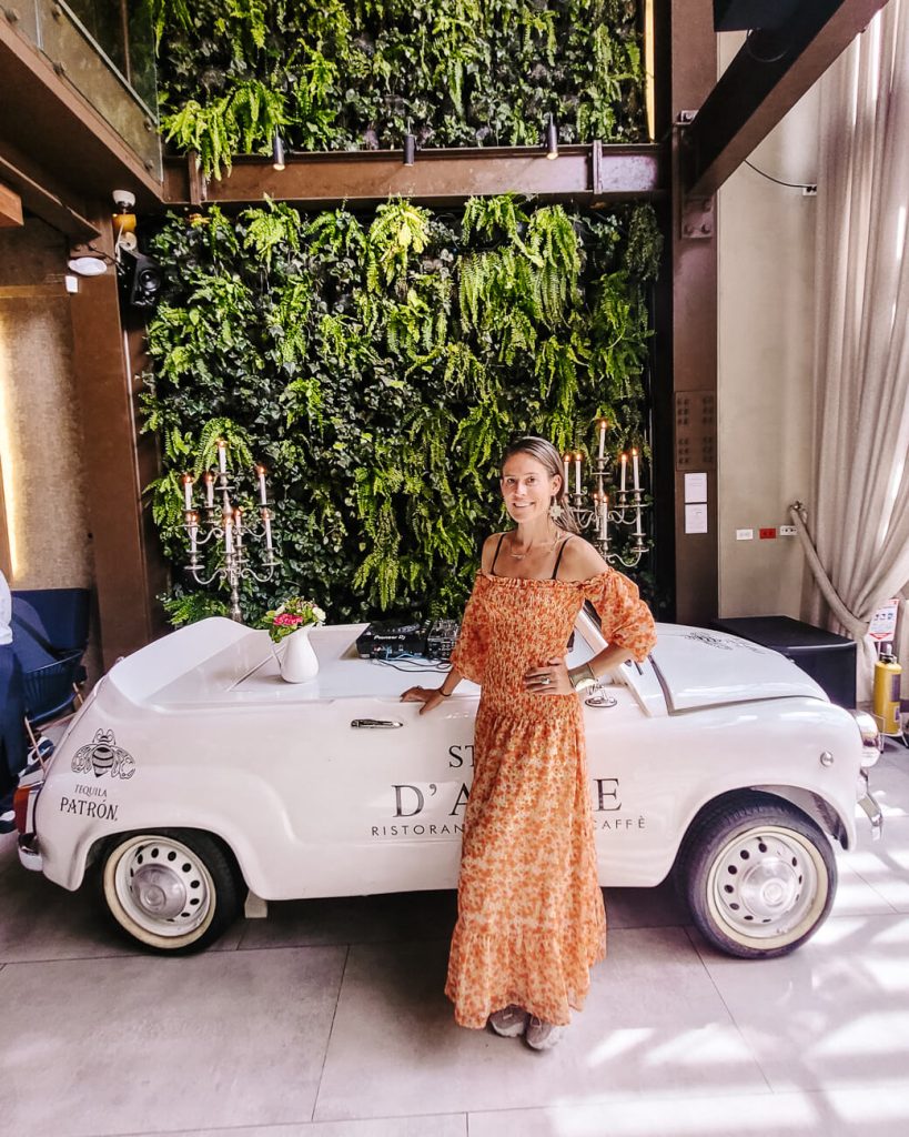 Deborah in front of car in Storia d'Amore restaurant.