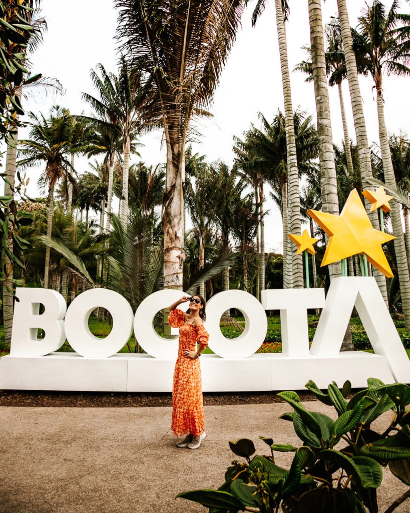 Deborah in front of Bogota sign in botanical garden