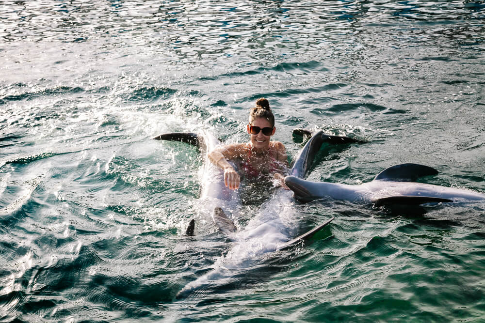 Deborah with dolphins at Oceanario Islas del Rosario in Colombia.