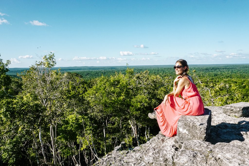 Deborah stting on temple and enjoying view from La Danta temple at El Mirador Guatemala