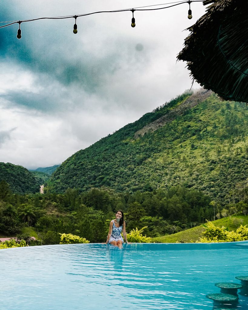 girl in swimmingpool Zephyr lodge in Lanquin