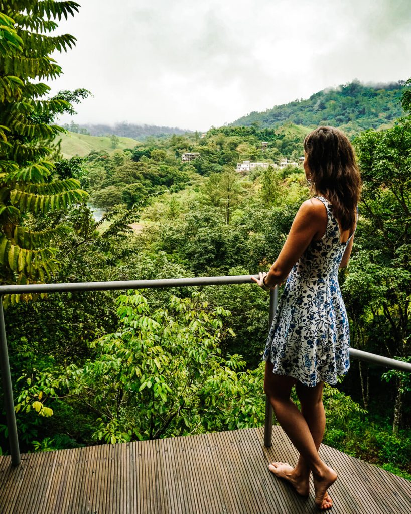 woman at balcony in Zephyr lodge in Lanquin