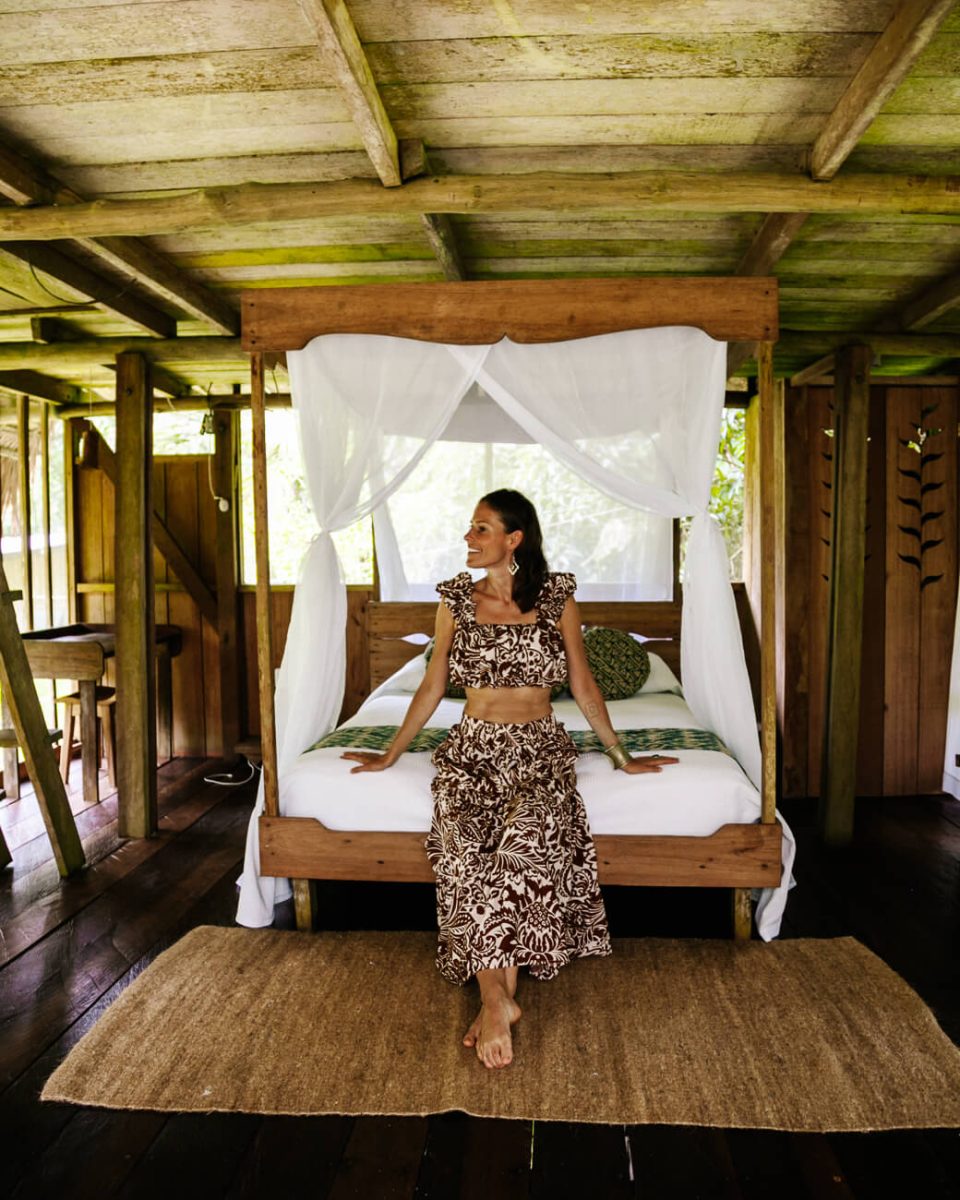 Deborah on bed in room in Calanoa Amazonas jungle lodge in Colombian Amazon 