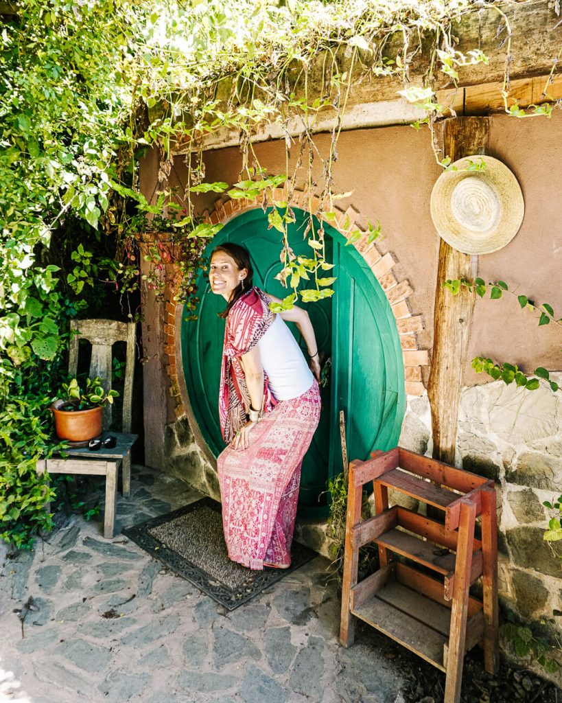 Deborah front of hobbit house in Hobbitenango.