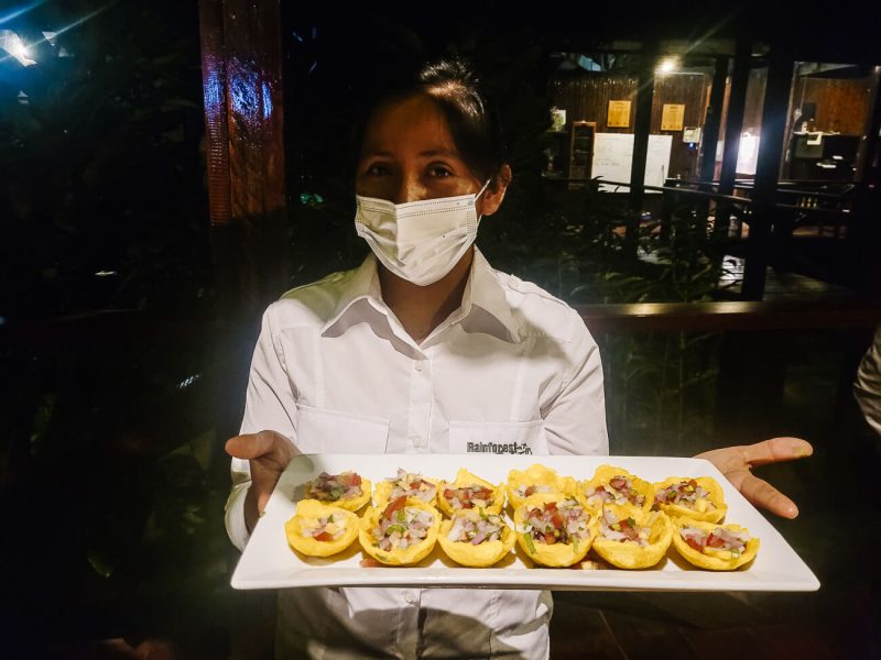 Crew with dishes at Refugio Amazonas - jungle lodge Tambopata Peru, by Rainforest Expeditions.