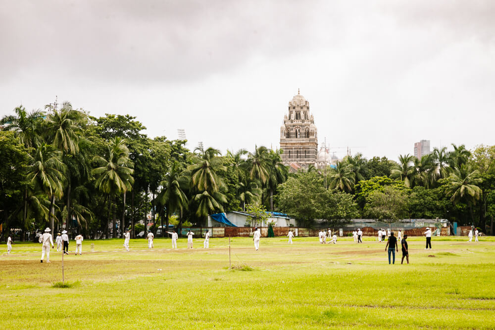 Oval Maidan is a large open field surrounded by palm trees in the Colaba neighborhood.