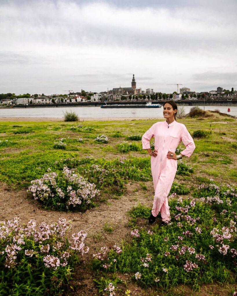 Deborah aan de Waal met uitzicht op Nijmegen. Via de snelbinder of Waalbrug, loop je vanuit het oude centrum van Nijmegen zo naar stadseiland Veur-Lent. Een plekje waar je kunt wandelen, suppen of bij mooi weer relaxen op het strandje. Foto tips: Bovendien heb je hier beste uitzicht op het centrum  van Nijmegen en maak je mooie foto’s. 