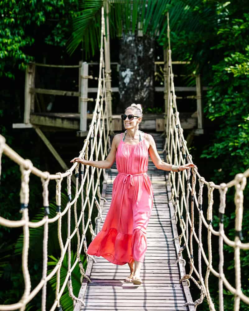 Deborah op hangbrug in tropisch regenwoud.